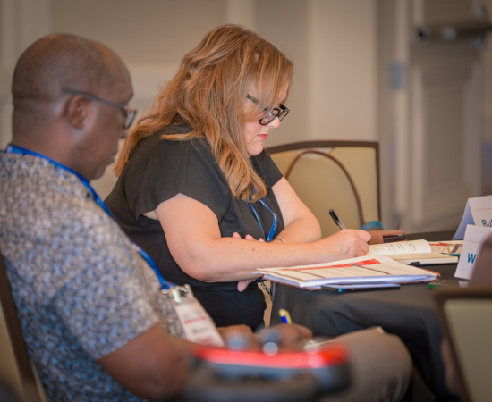 Jeffery A Robinson and Donna Souder Hodge take notes at NPA 2024.
